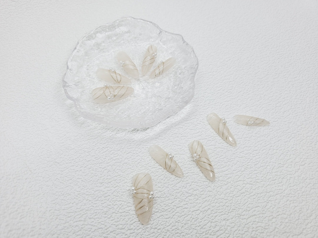 Blooming Pearls: Nude Nails with Floral Designs and Pearl Accents Instant Mani